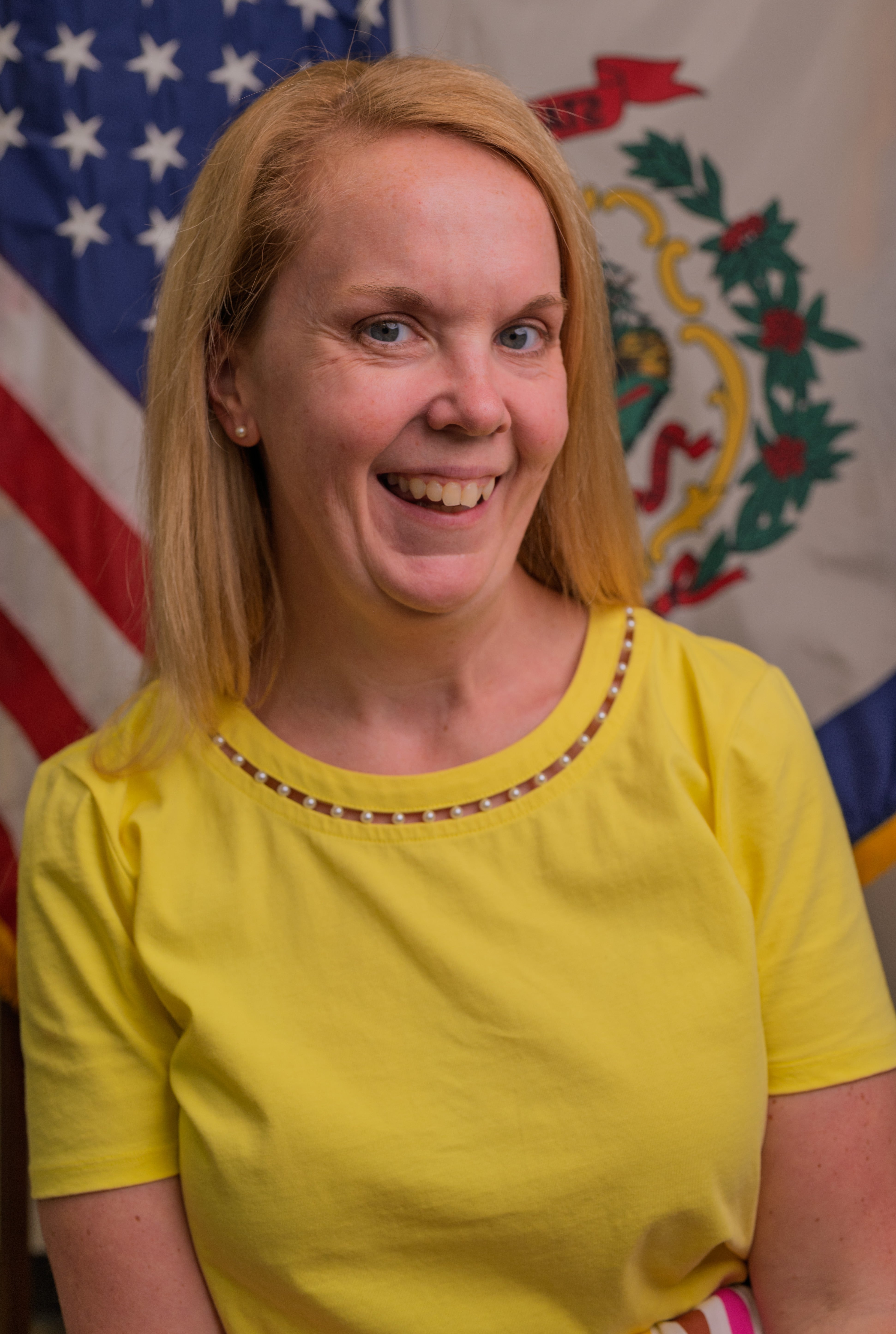 Portrait of Jessica Wintz-Adams taken in front American Flag and WV State Flag