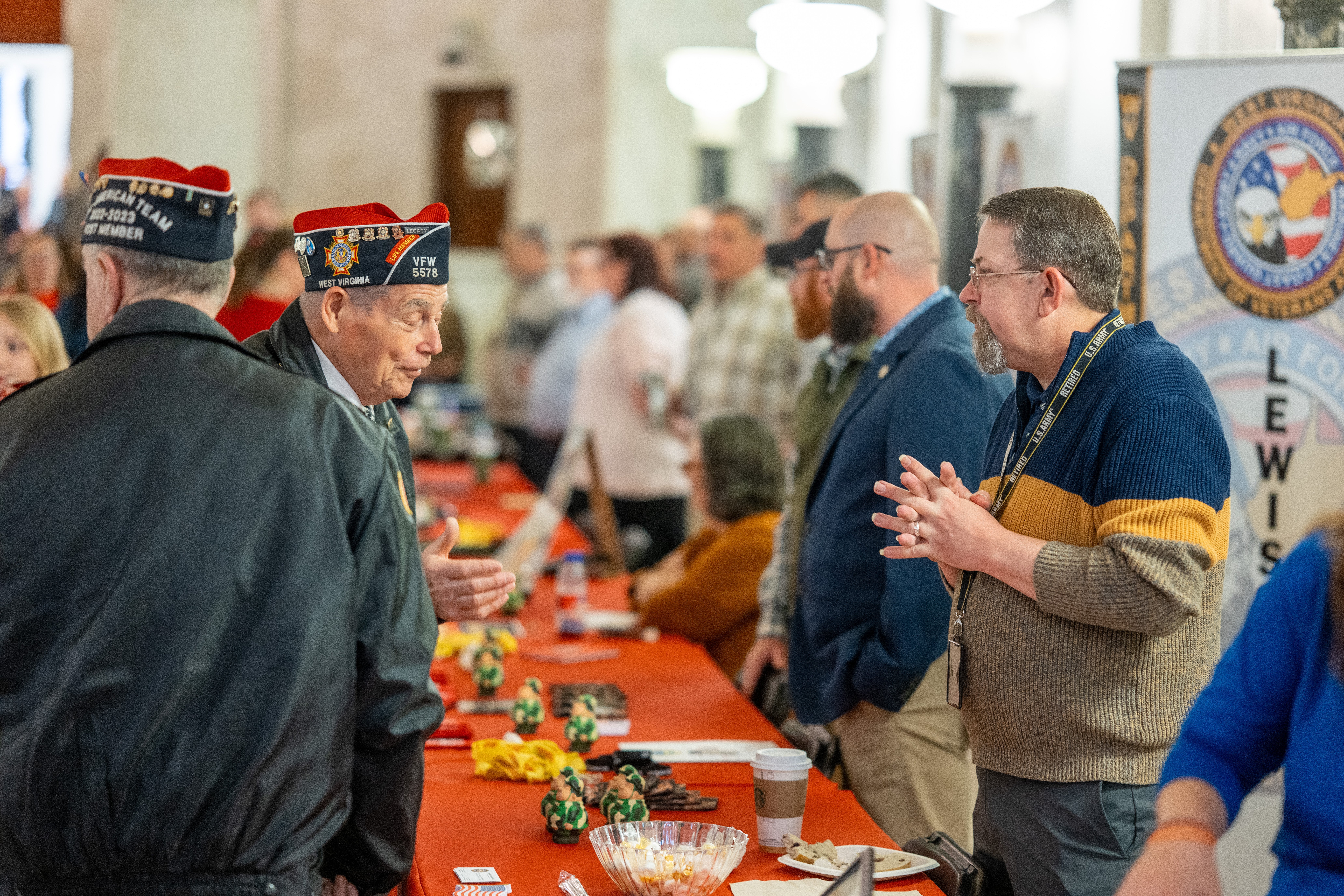 VSOs from the WV Department of Veterans Assistance engage with veterans at an info table