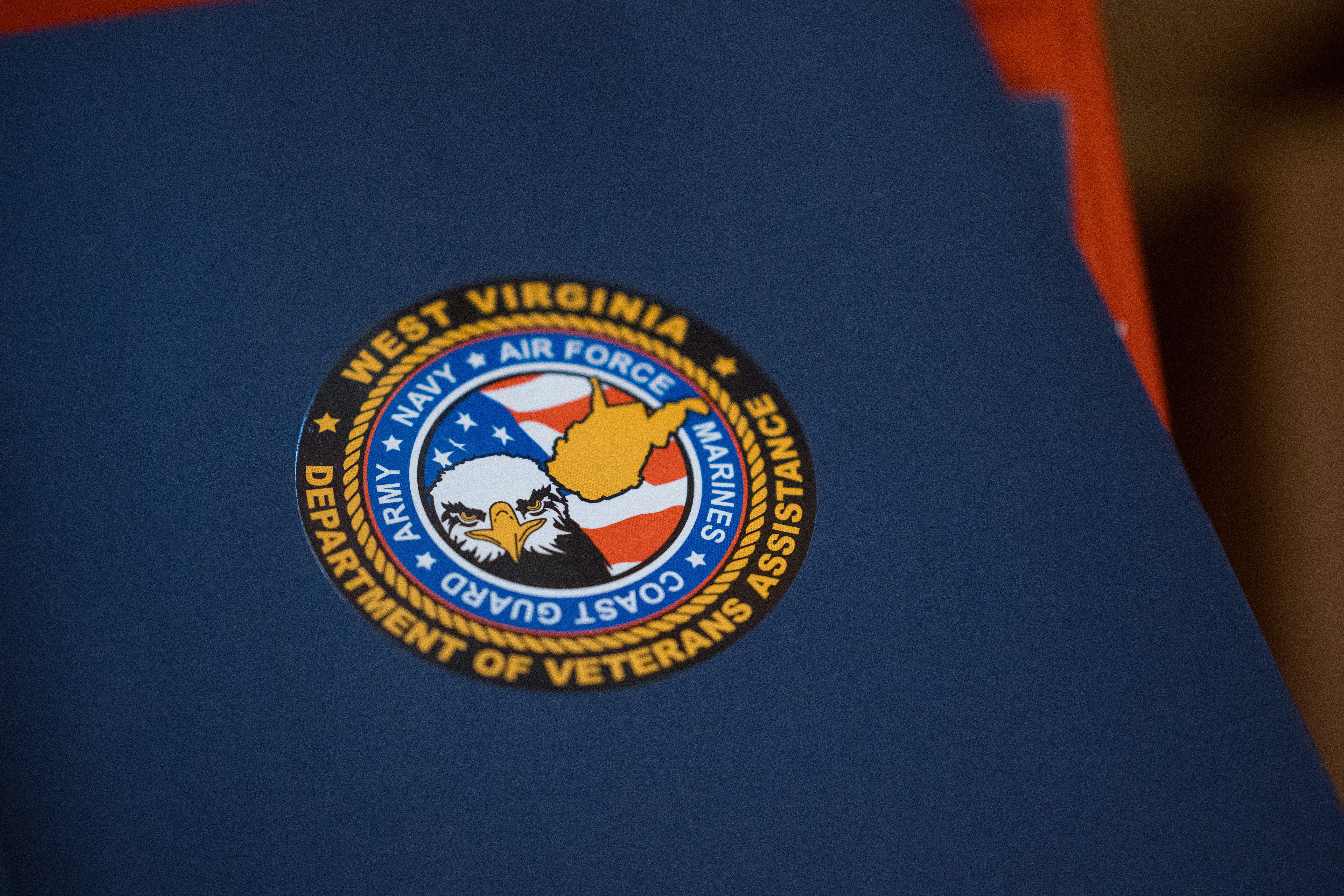 Blue folder with the West Virginia Department of Veterans Assistance logo features in center.