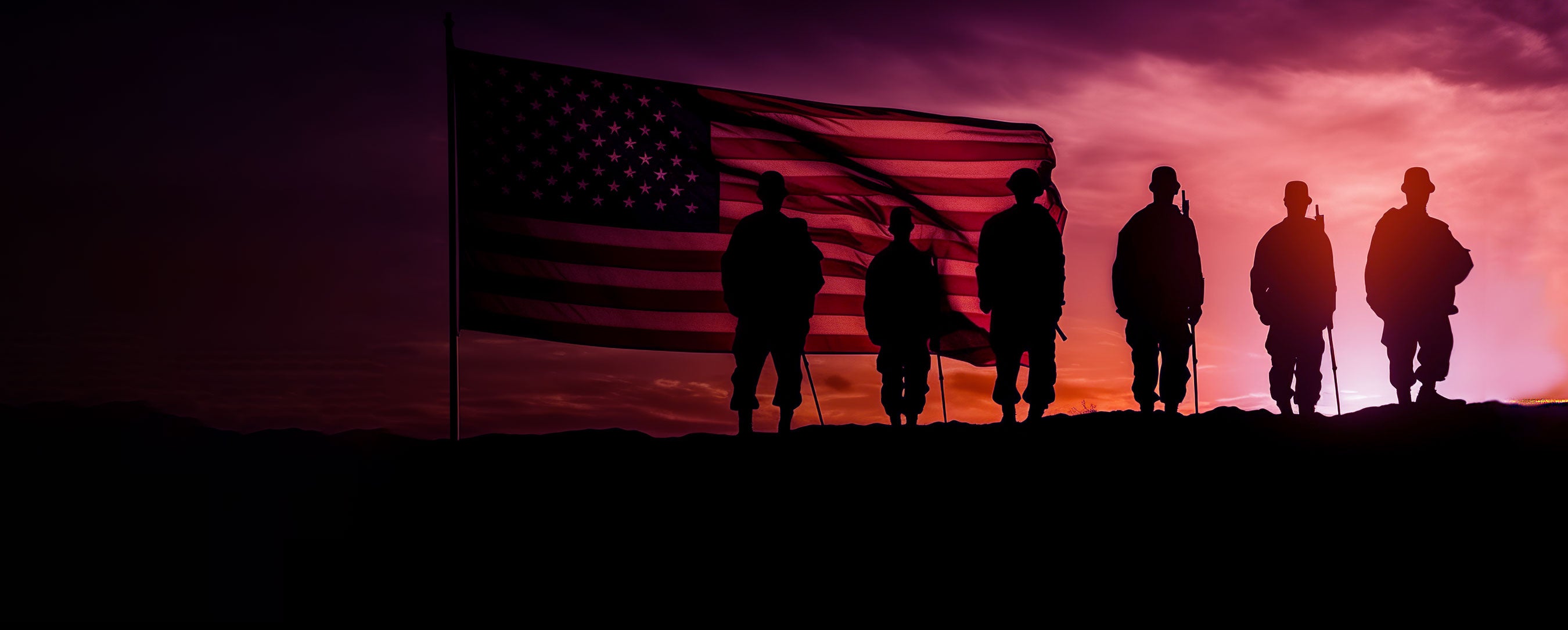 Soldiers standing in front of the United States of America flag