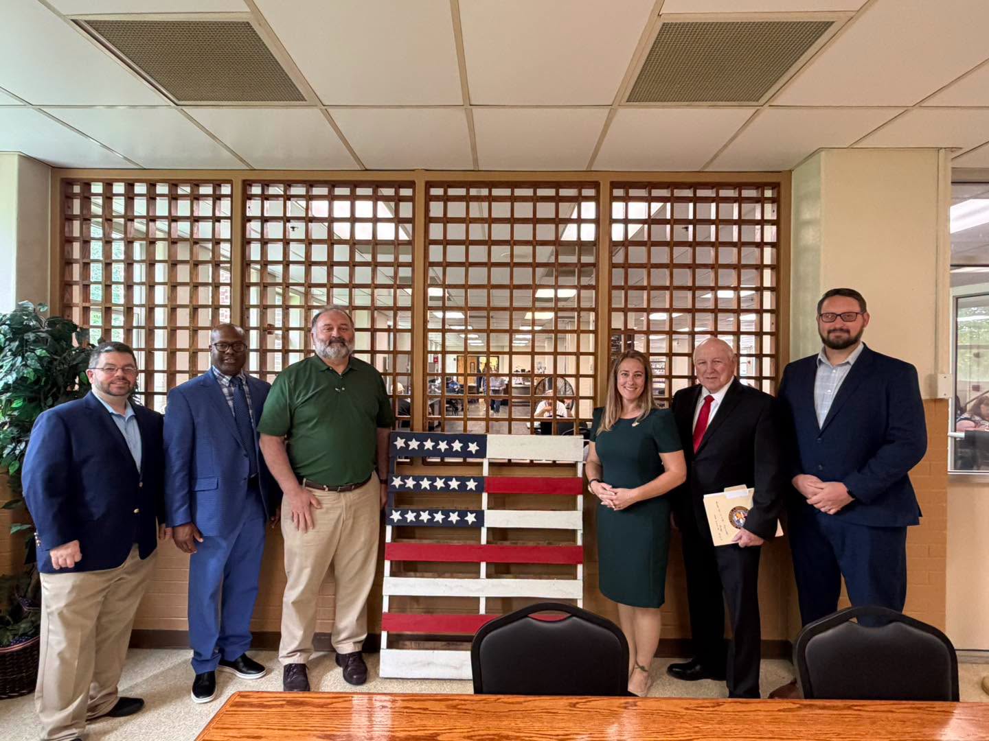 Six members of the Veterans Council pose in front of a table.